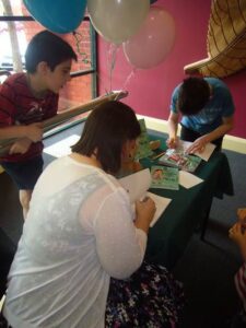 Signing books, Nat signed some books too!